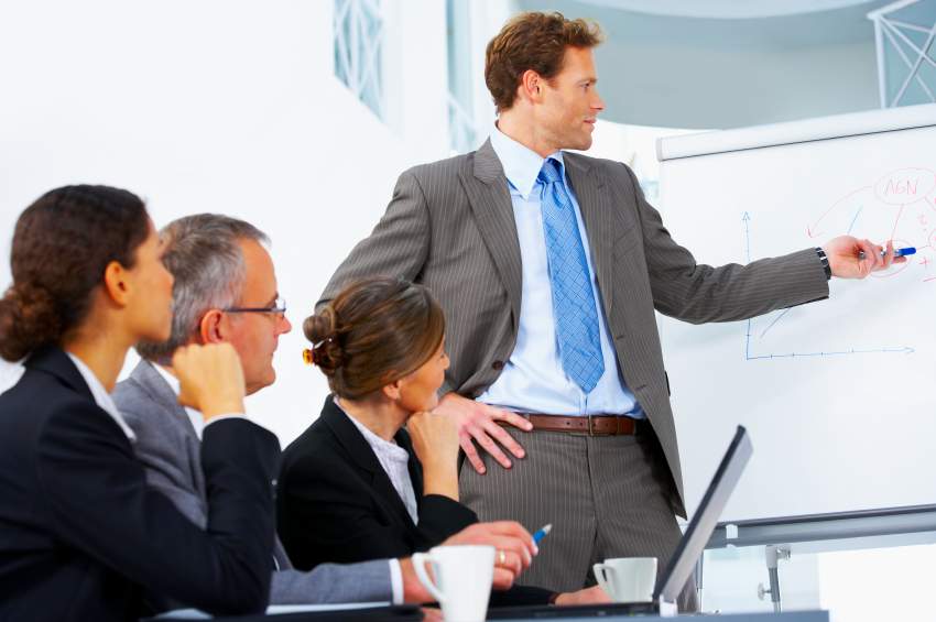 Young speaker at a business meeting giving a presentation.